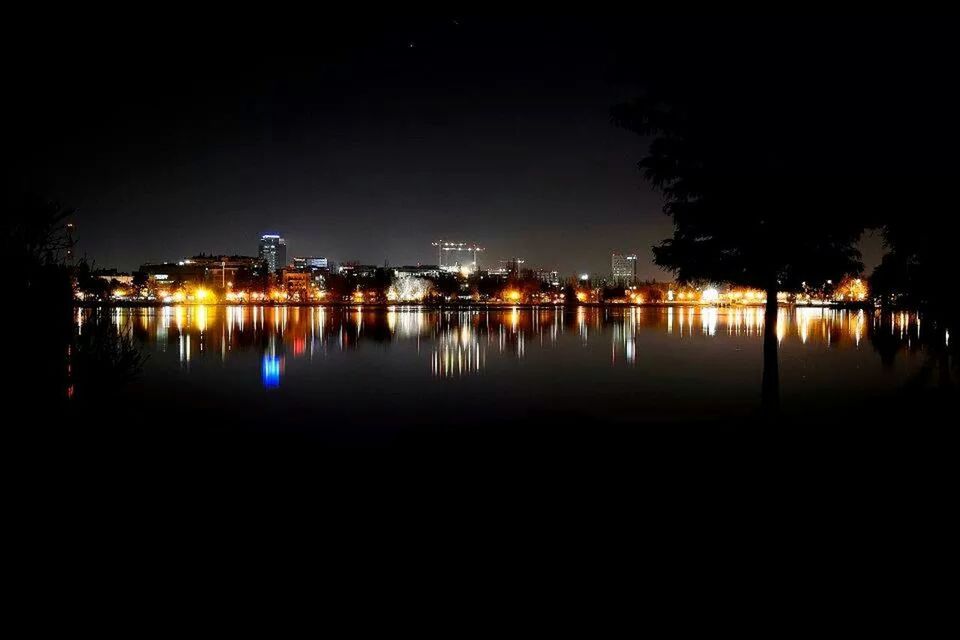 City lit up at night at waterfront