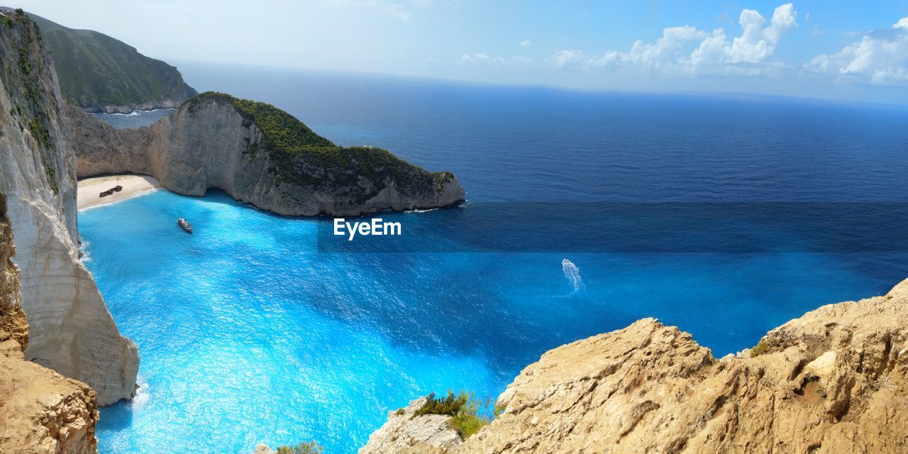 PANORAMIC VIEW OF SEA AND ROCKS AGAINST SKY