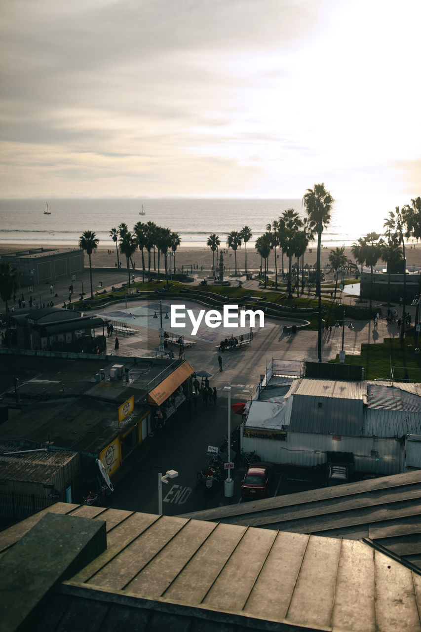 HIGH ANGLE VIEW OF PIER AT HARBOR DURING SUNSET