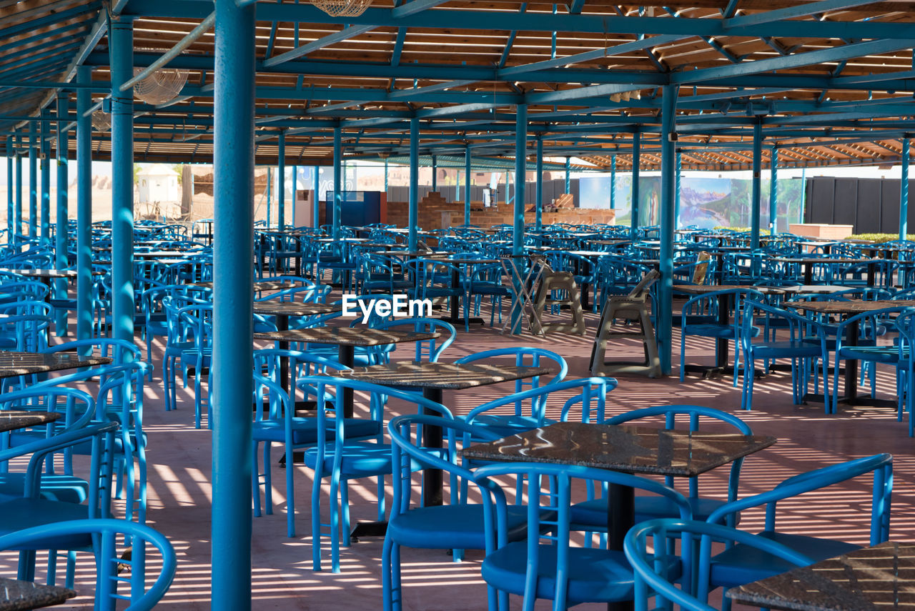 VIEW OF AN EMPTY CHAIRS AND TABLES IN WAREHOUSE