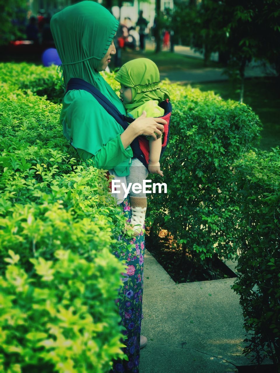 Rear view of women standing on plants