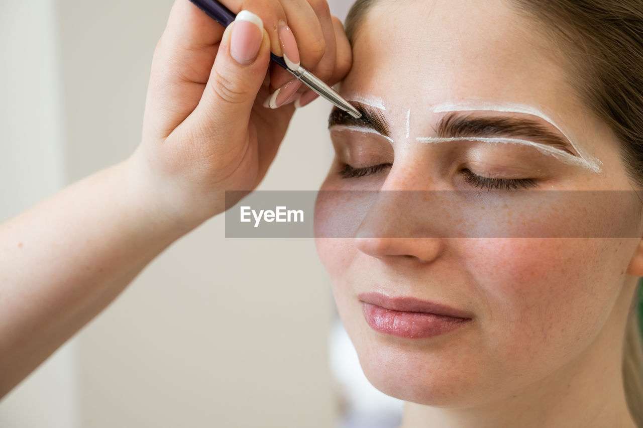 cropped image of woman applying nail