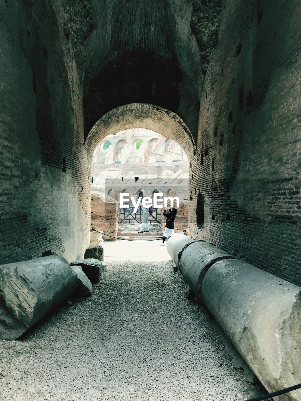 MAN WALKING IN TUNNEL