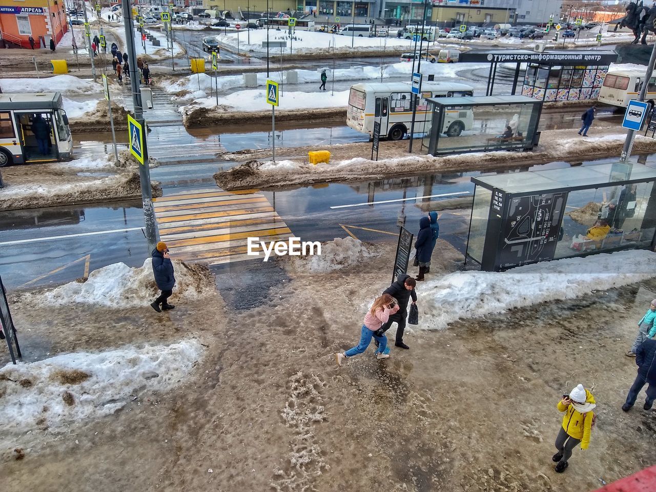 HIGH ANGLE VIEW OF PEOPLE AT CONSTRUCTION SITE IN WATER