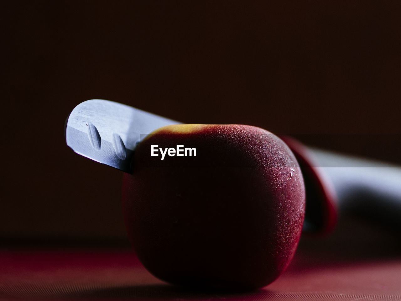 Close-up of apple on table against black background