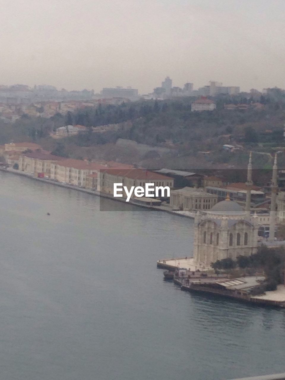 VIEW OF RIVER WITH BUILDINGS IN BACKGROUND