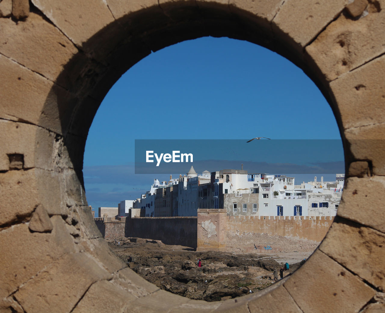 BUILDINGS BY SEA AGAINST CLEAR SKY