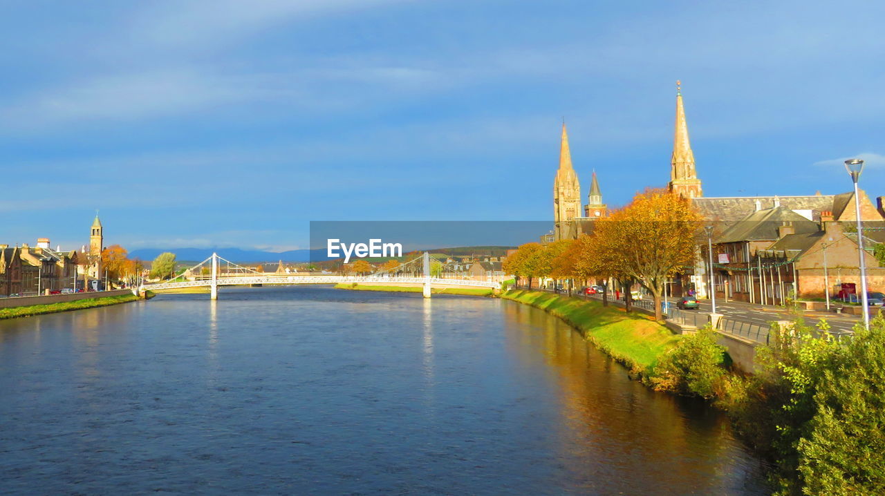 VIEW OF RIVER WITH BUILDINGS IN BACKGROUND