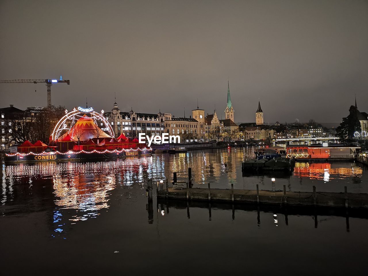 ILLUMINATED BUILDINGS AT WATERFRONT