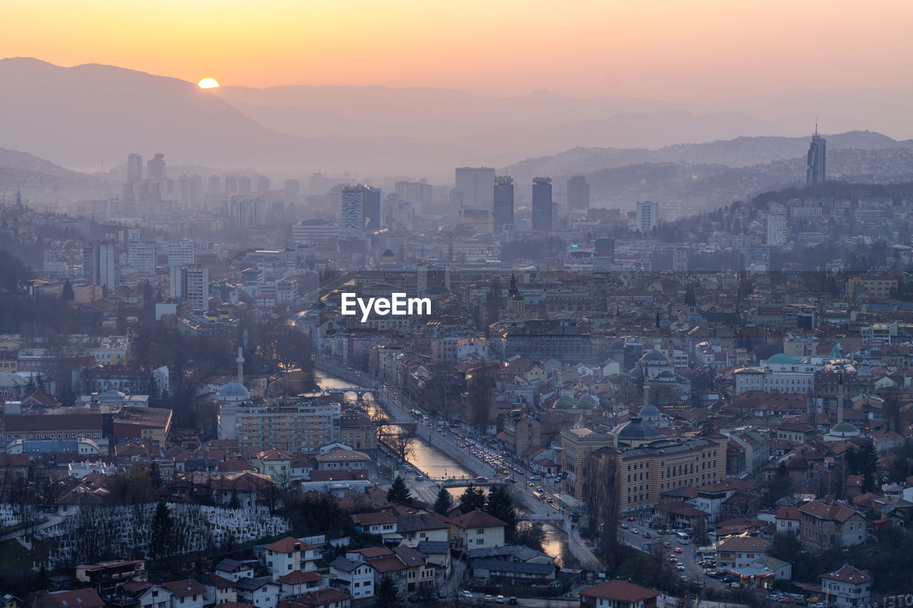 High angle view of city at sunset