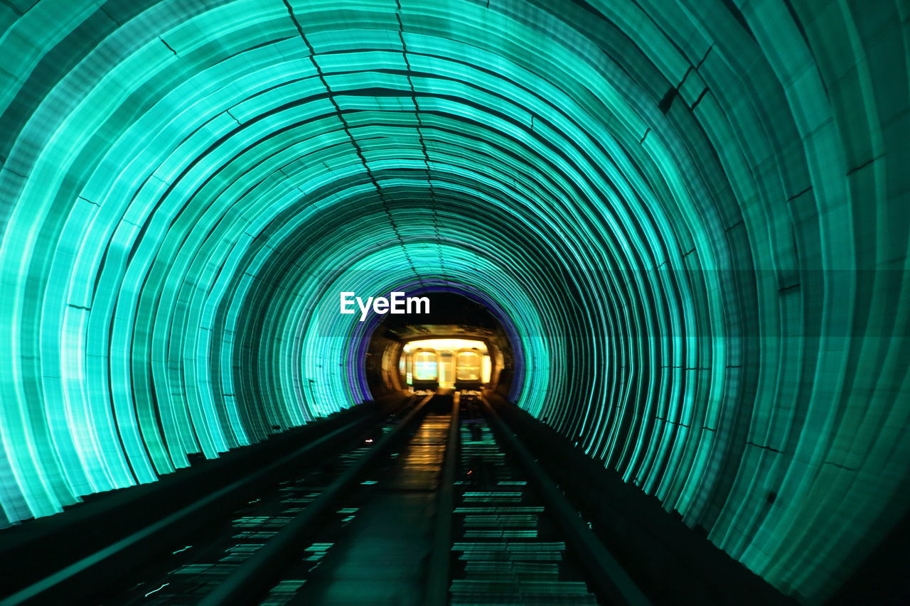 ILLUMINATED TUNNEL SEEN THROUGH SUBWAY