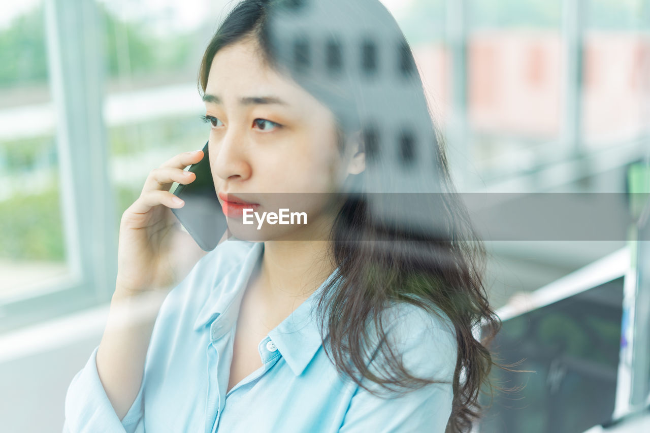 portrait of young woman talking on mobile phone