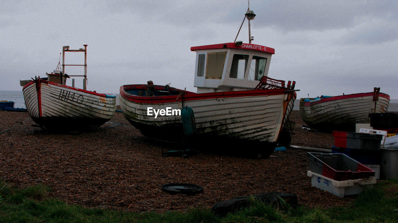 Boats at beach against sky