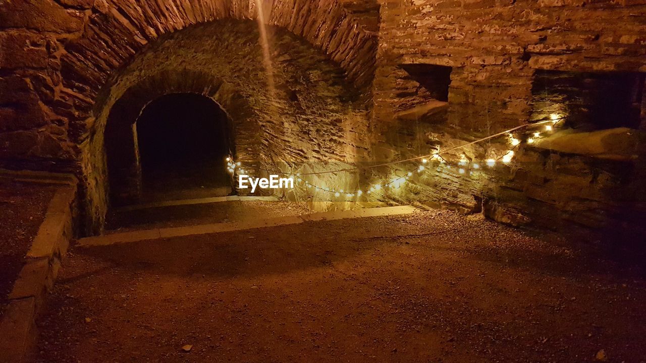 ILLUMINATED TUNNEL SEEN THROUGH WALL