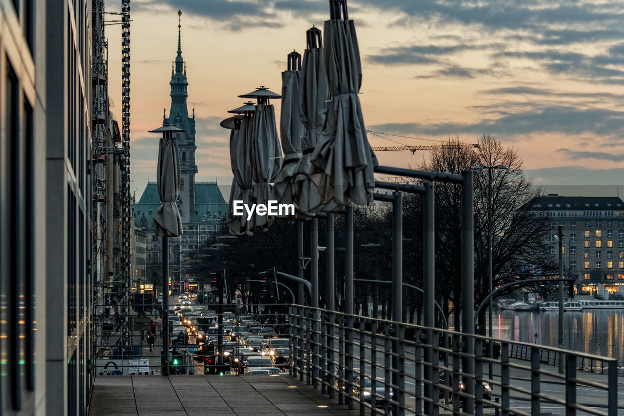 Parasols against hamburg rathaus in city during sunset