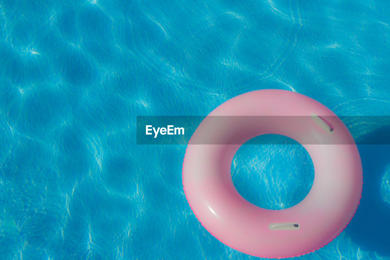 High angle view of pink inflatable ring floating on water