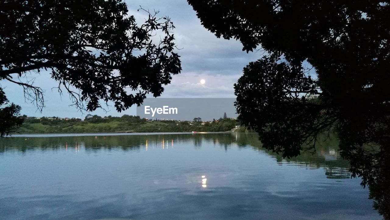 Reflection of trees in lake against sky