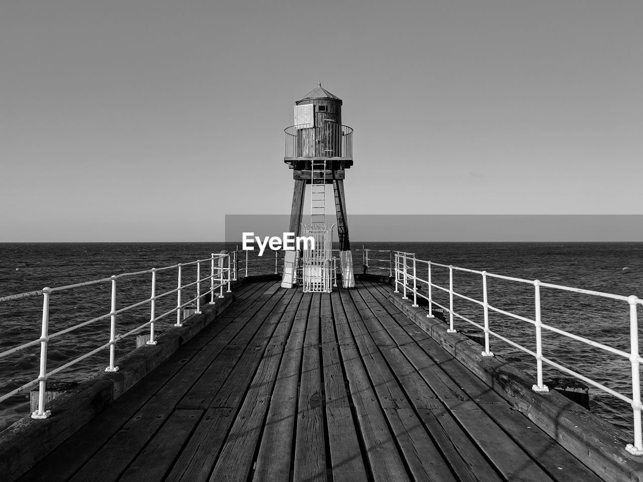 Pier over sea against clear sky