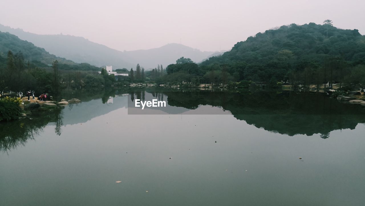 Scenic view of lake and mountains against sky