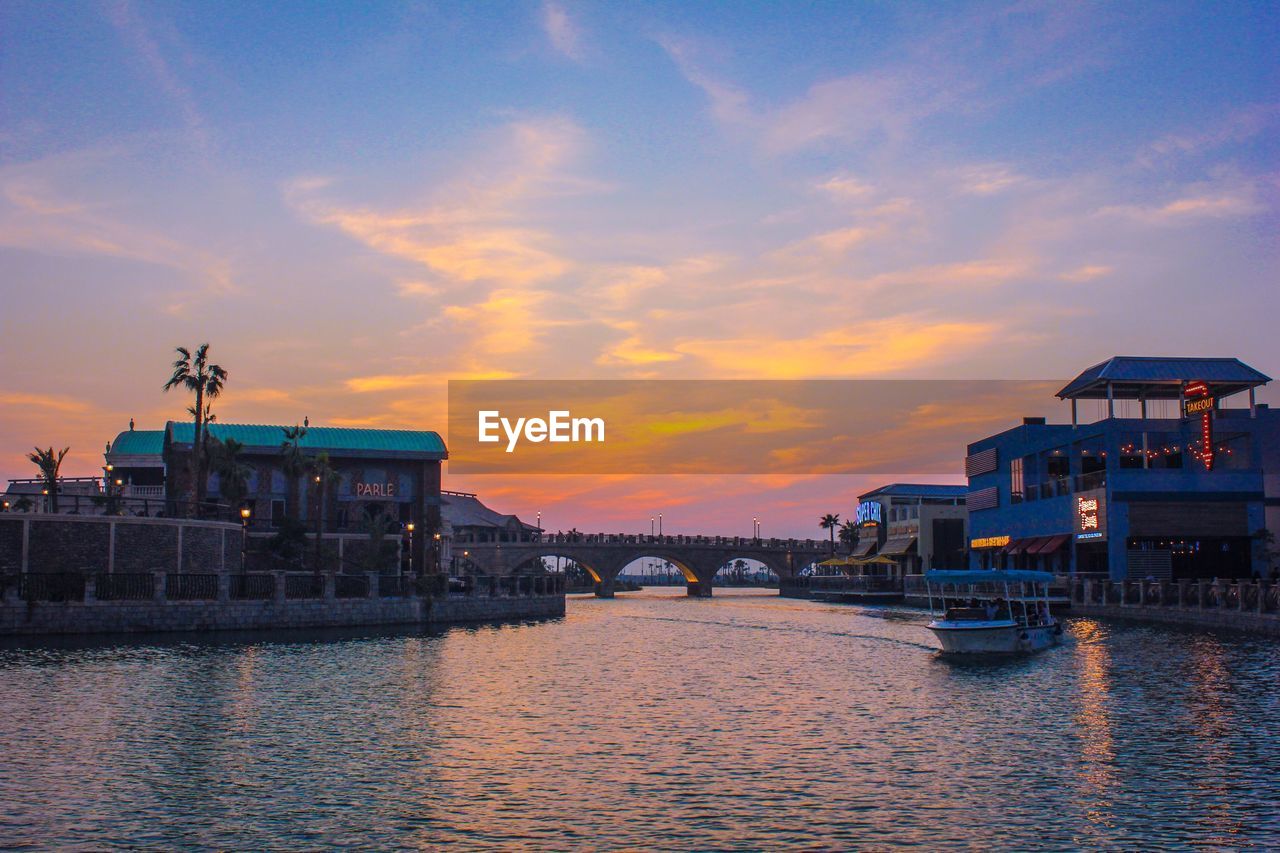 Scenic view of river against sky at sunset