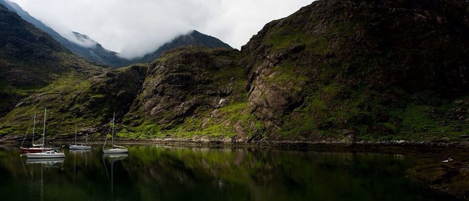 Scenic view of mountains by river