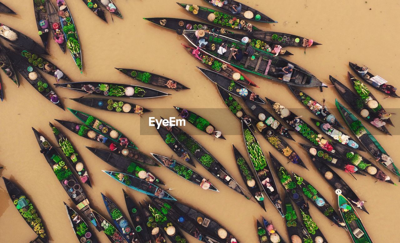 High angle view of vendors selling vegetables on rowboats in river