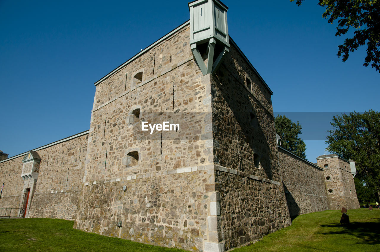 LOW ANGLE VIEW OF CASTLE AGAINST BLUE SKY