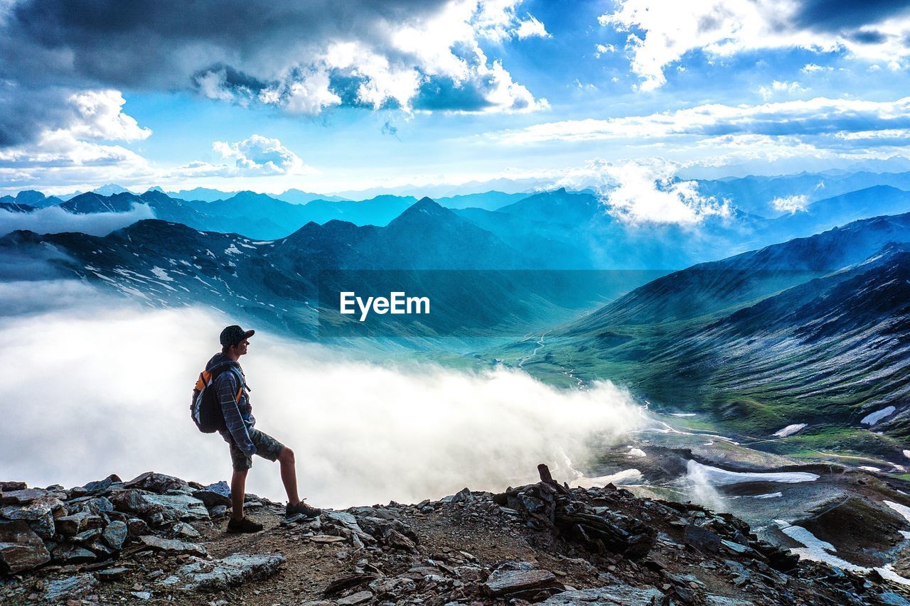 Man standing on mountain against sky