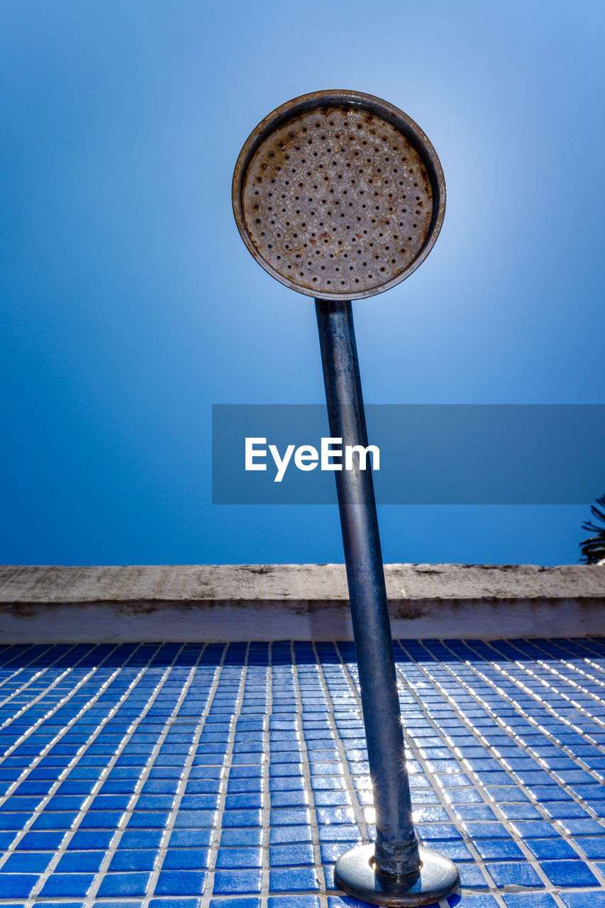 CLOSE-UP OF SWEET FOOD ON METAL AGAINST BLUE SKY