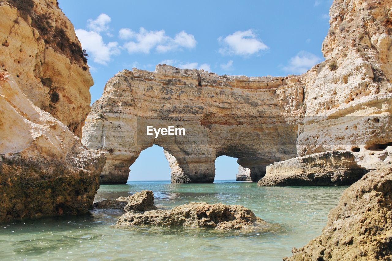 Scenic view of stack rock at praia da marinha against sky