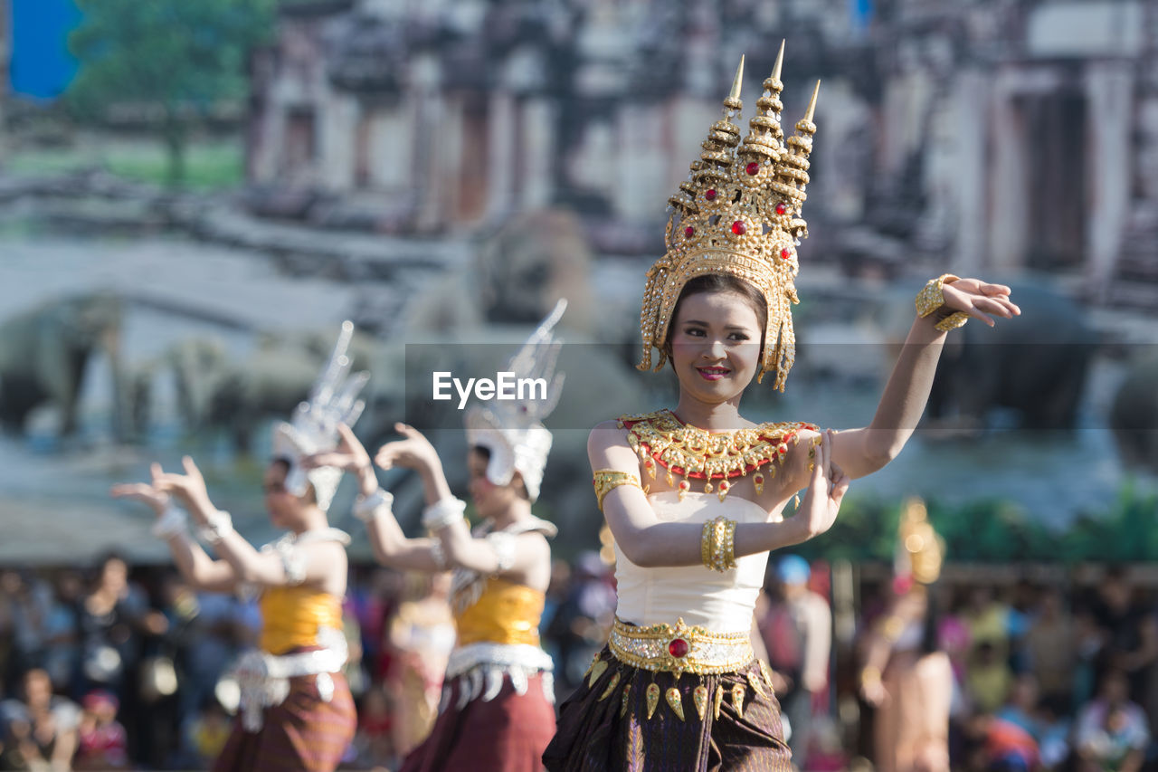 WOMAN IN TRADITIONAL CLOTHING AT TEMPLE