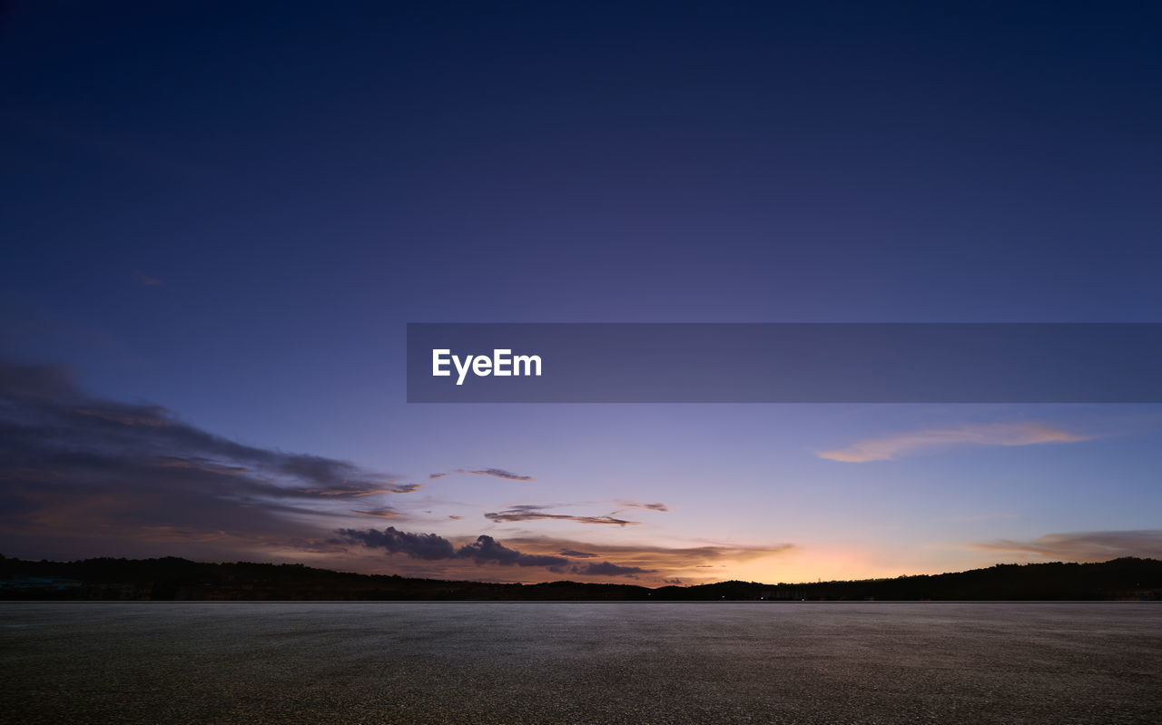 scenic view of mountains against clear sky during sunset