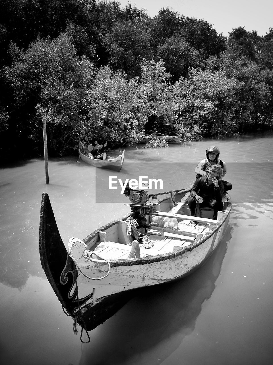 PEOPLE ON BOAT IN RIVER