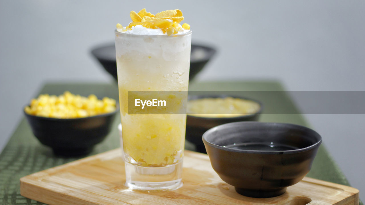 CLOSE-UP OF DRINK WITH JUICE ON TABLE