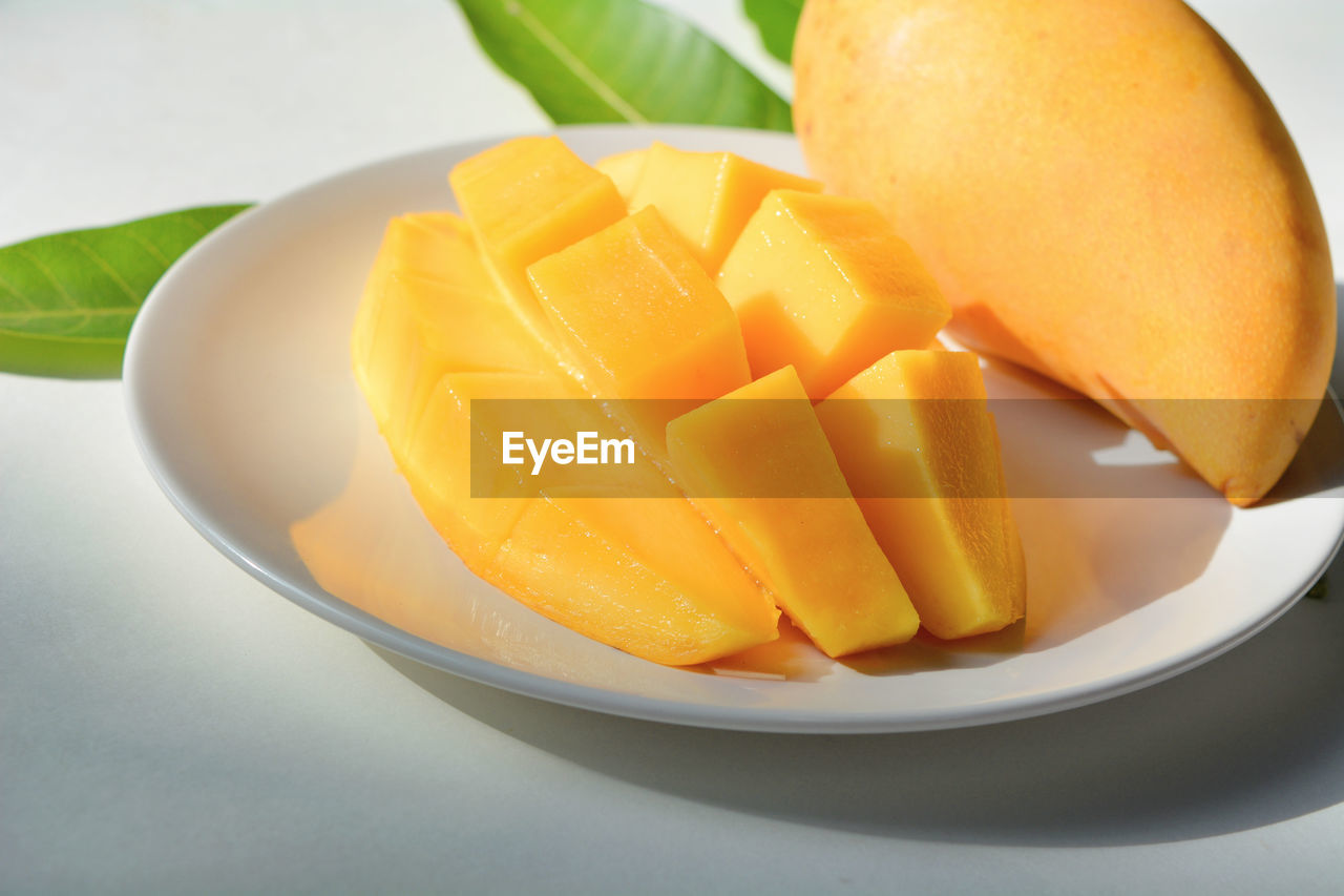 Mango fresh ready to eat EyeEm Selects Bowl Chopped Close-up Food Food And Drink Freshness Fruit Healthy Eating High Angle View Indoors  Mango Fruit No People Plate SLICE Still Life Table Wellbeing Yellow