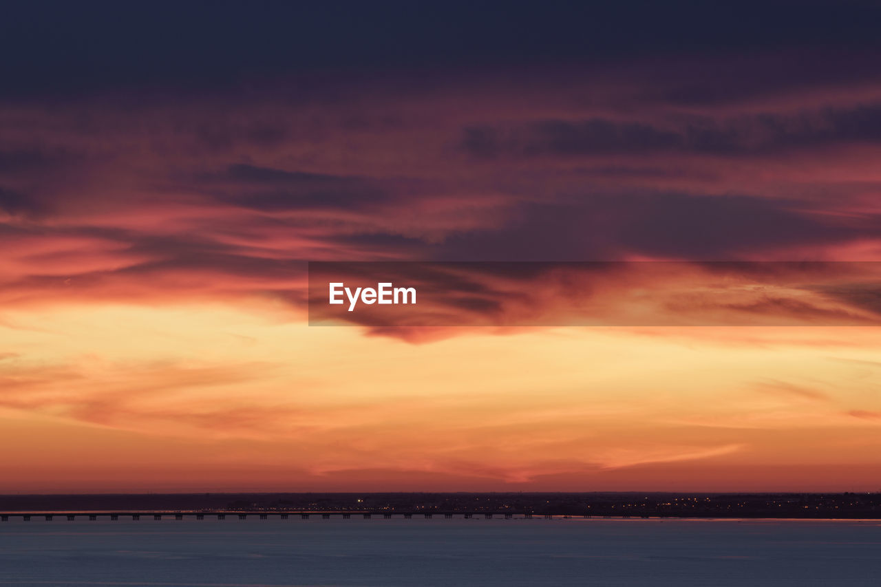 Scenic view of dramatic sky over sea during sunset