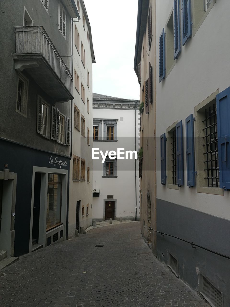 FOOTPATH AMIDST RESIDENTIAL BUILDINGS