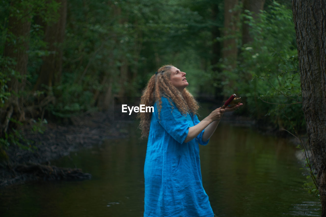 Woman standing in forest