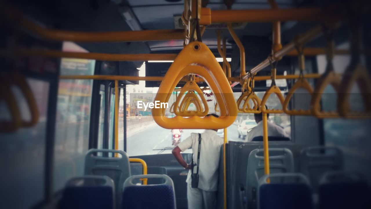 CLOSE-UP OF YELLOW TRAIN IN BUS