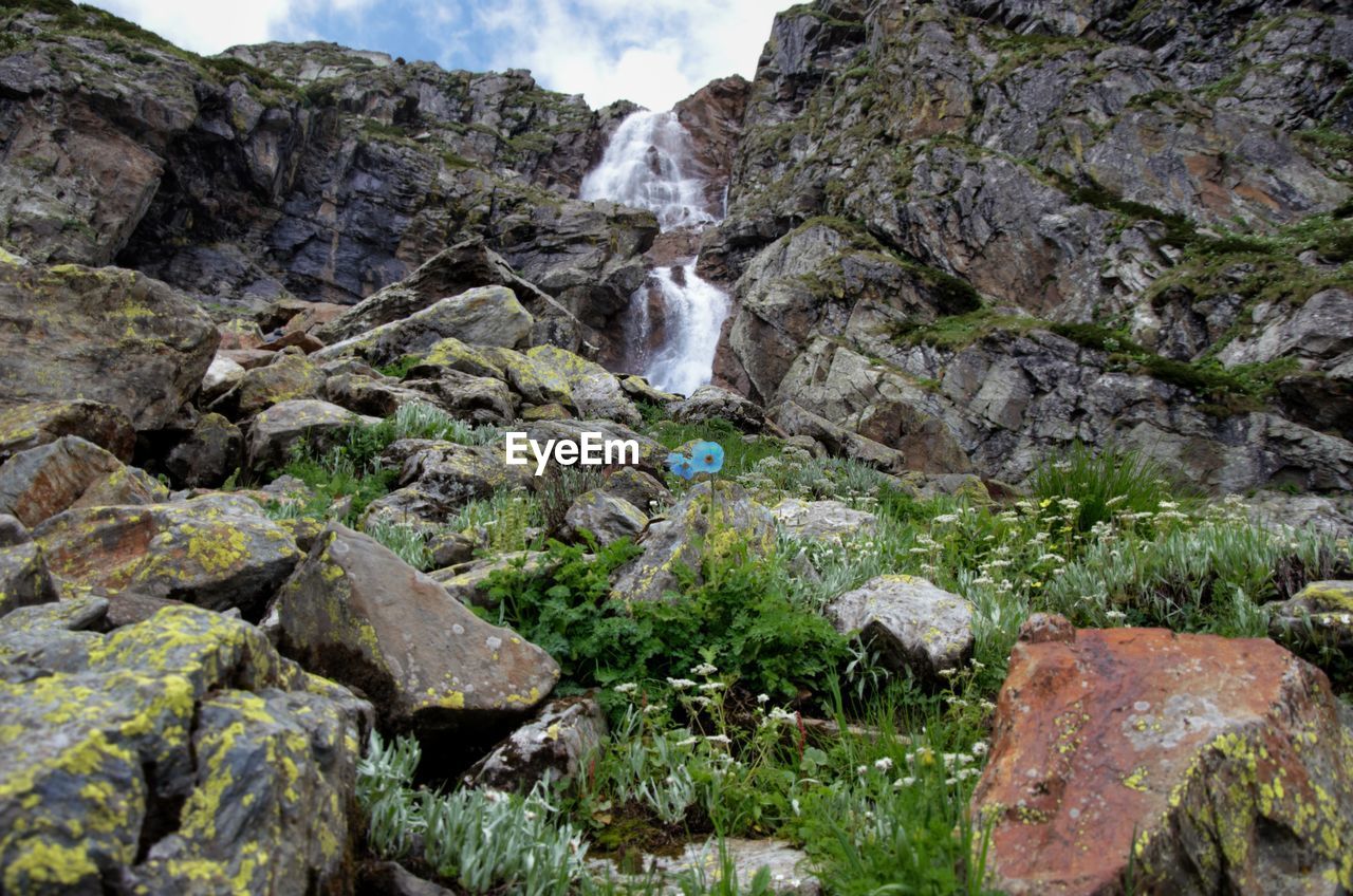 VIEW OF WATERFALL ALONG ROCKS