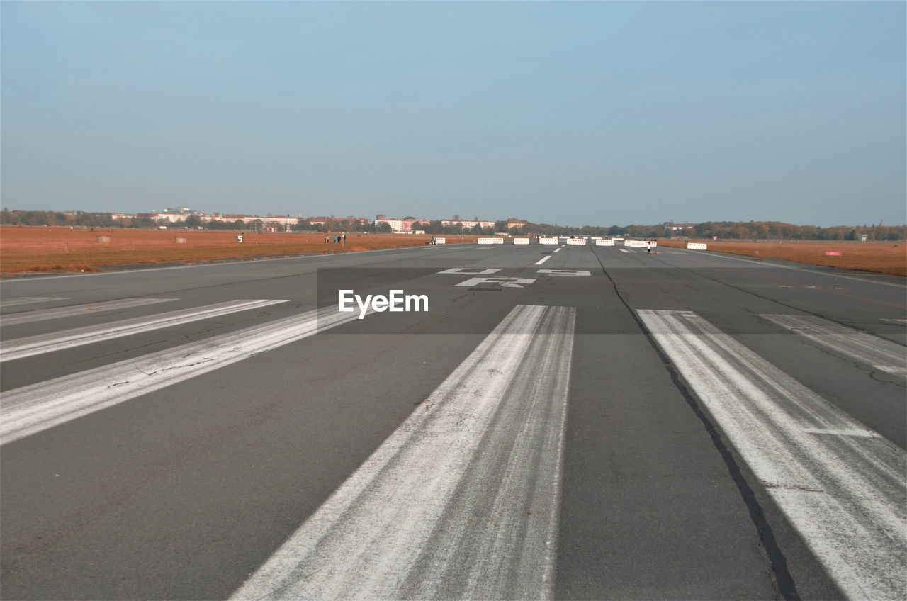 Airport runway against clear sky
