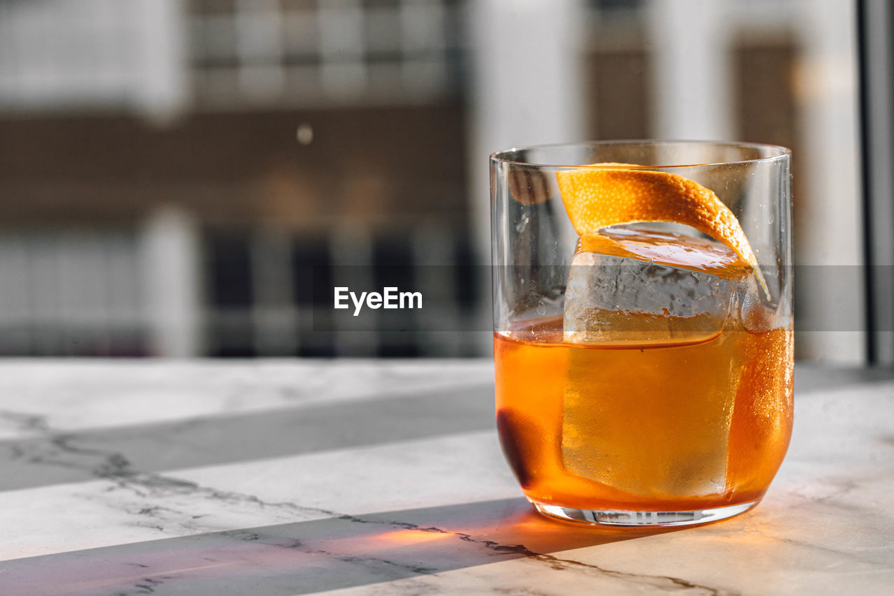 drink, refreshment, food and drink, drinking glass, household equipment, glass, alcohol, alcoholic beverage, cold temperature, table, distilled beverage, focus on foreground, beer, no people, whisky, close-up, yellow, architecture, freshness, outdoors, still life, beer glass