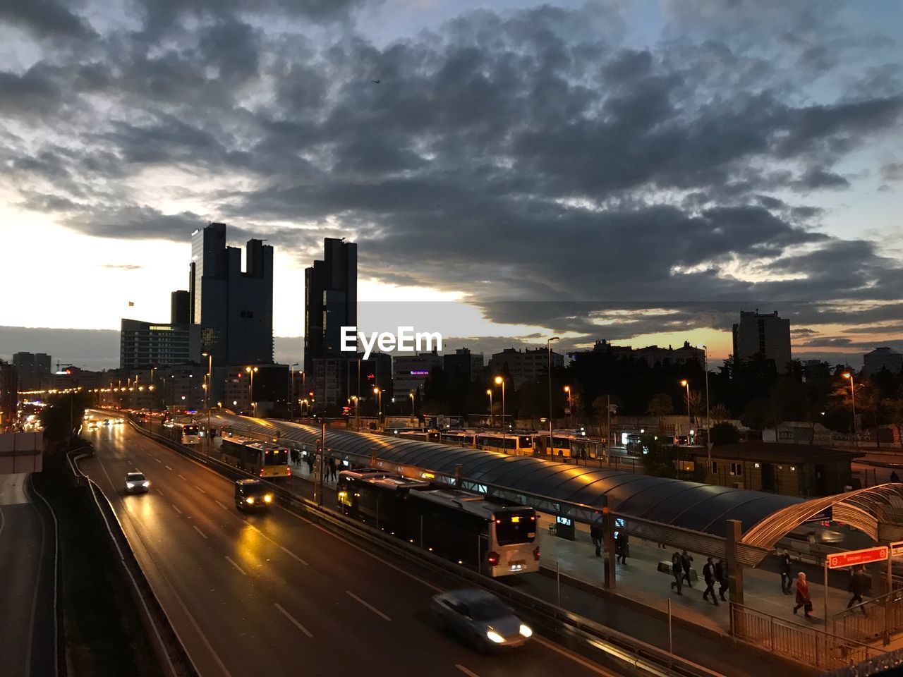 View of city street and buildings against sky