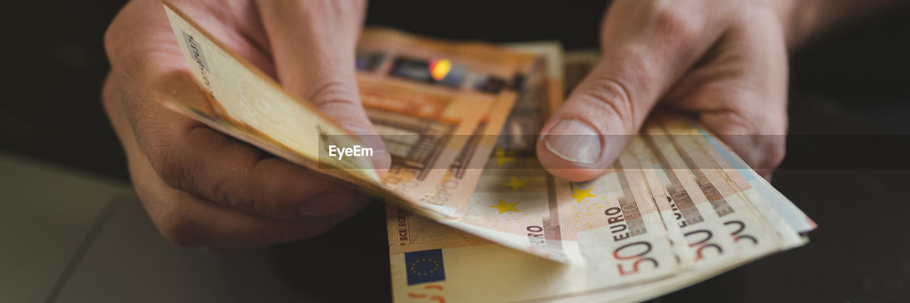 Business man counting money. male hands holds and count cash banknotes euros bills or notes currency