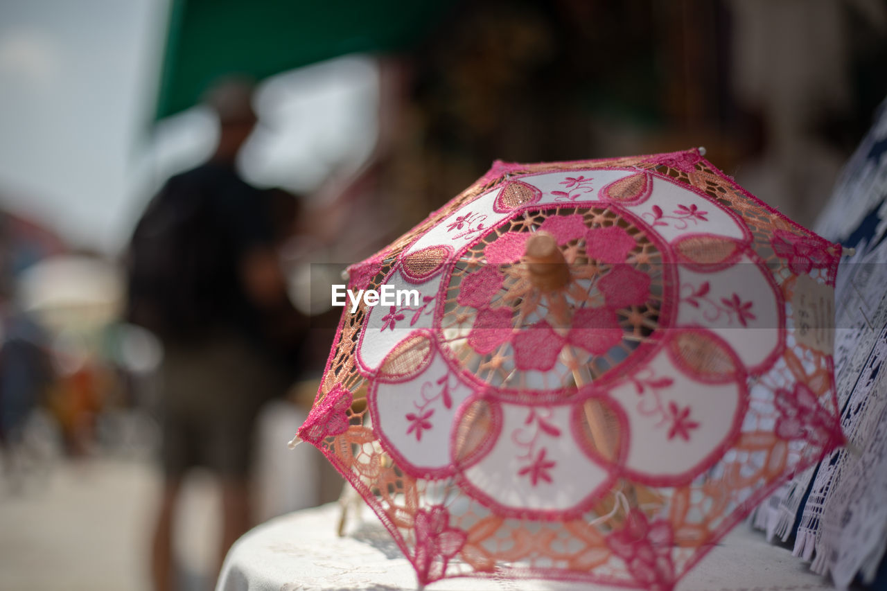 Close-up of figurine umbrella for sale at market