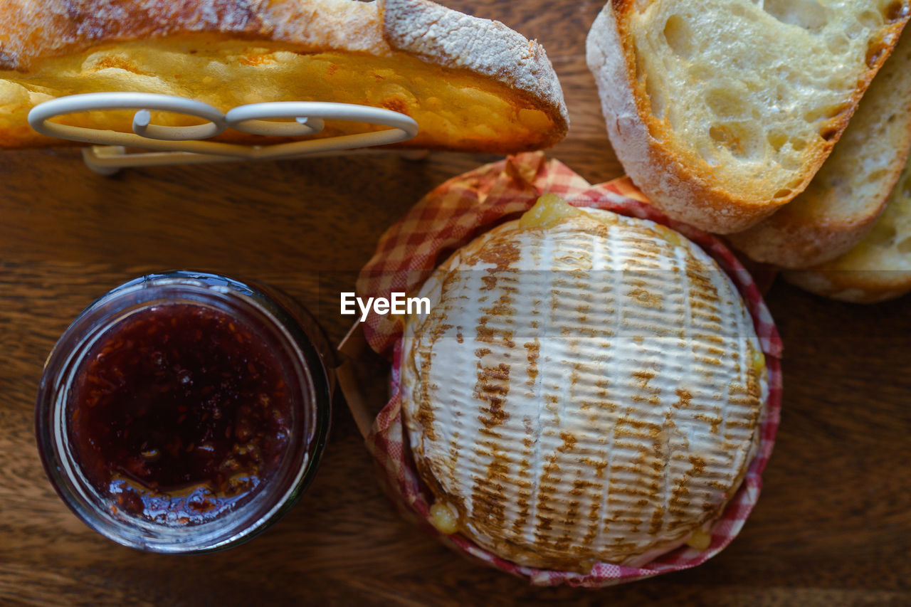 Directly above shot of camembert with jam bottle