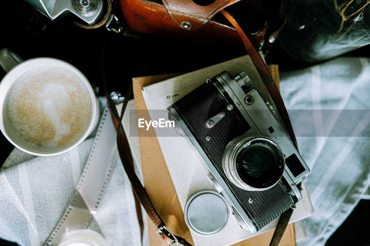 HIGH ANGLE VIEW OF CAMERA AND TABLE