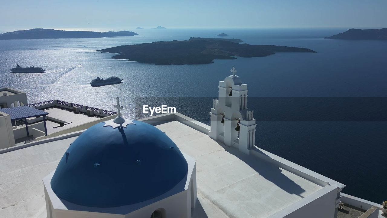 Three bells of fira, catholic church of the dormition, with the caldera in the background. santorini