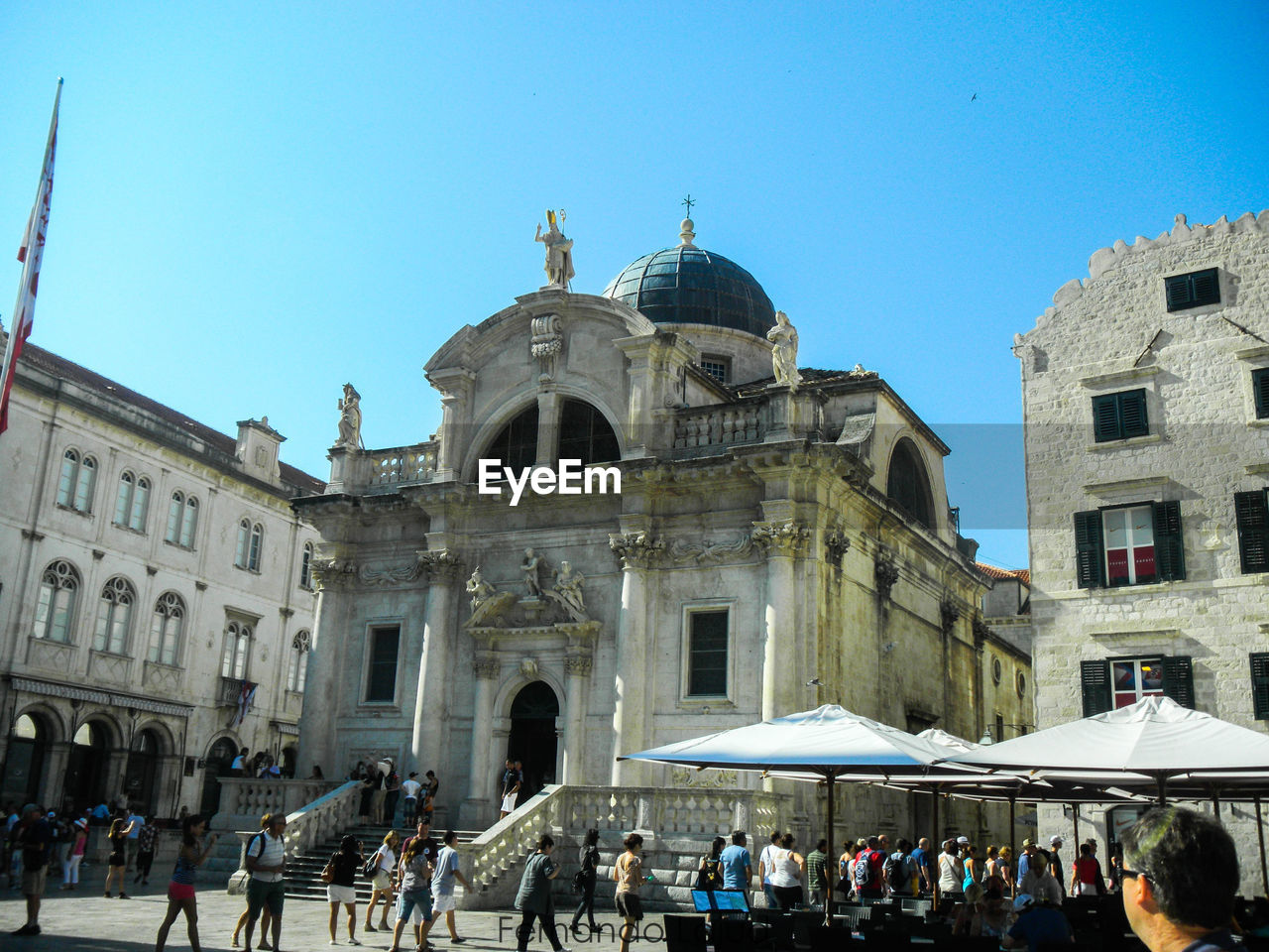 GROUP OF PEOPLE IN FRONT OF CHURCH