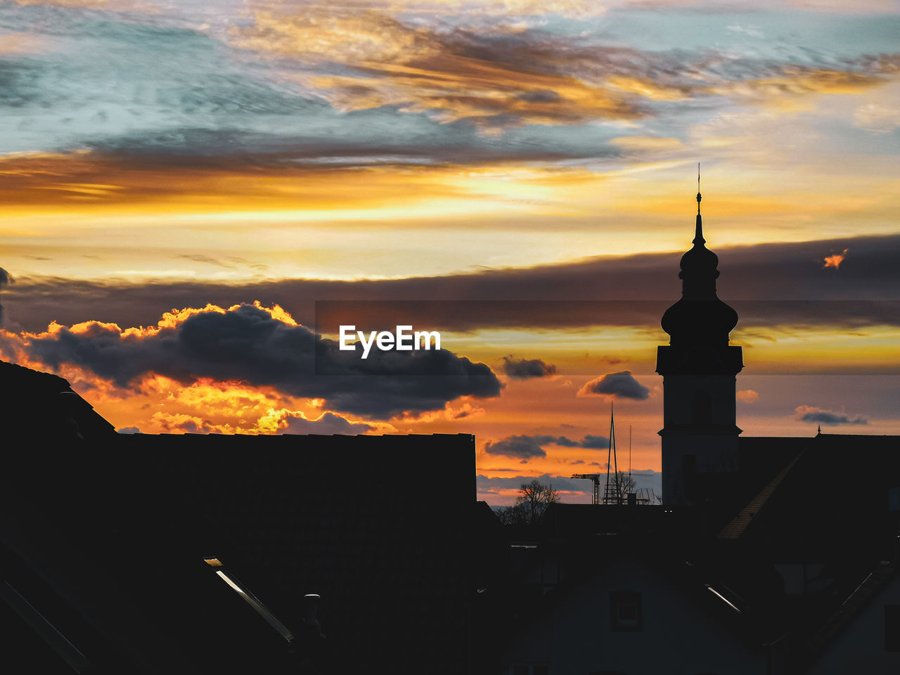 Silhouette buildings against sky during sunset